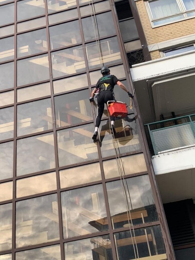 Abseiler cleaning windows on a tower block