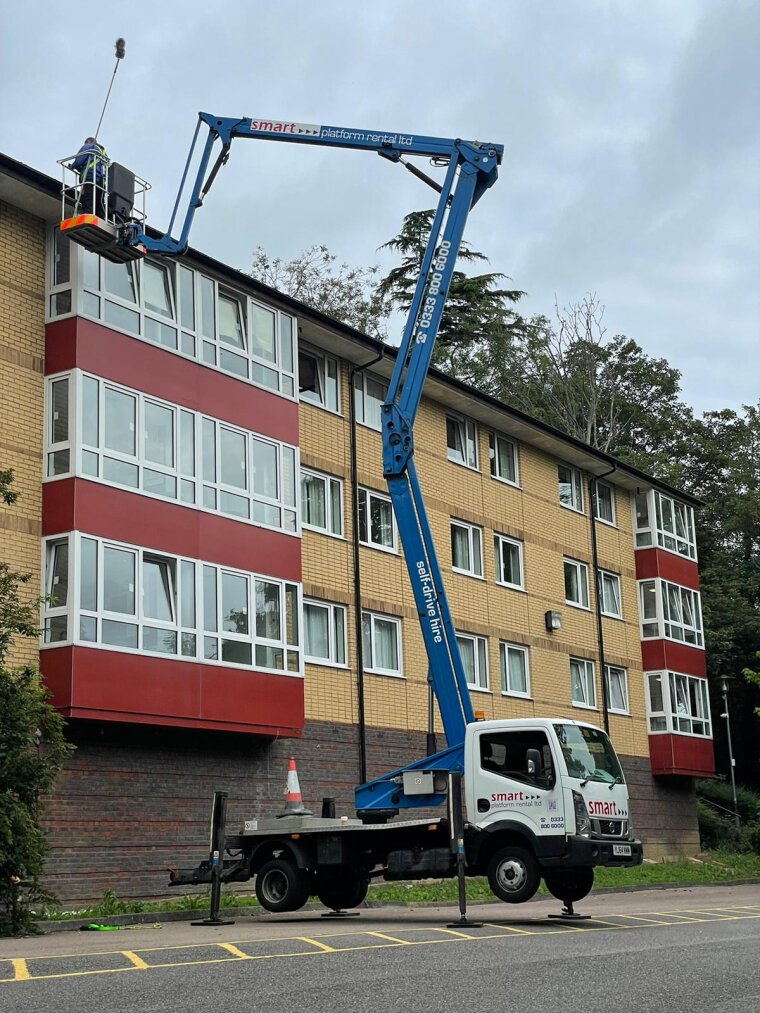 Loory with cherry-picker giving access to clean windows in multi-storey buildings