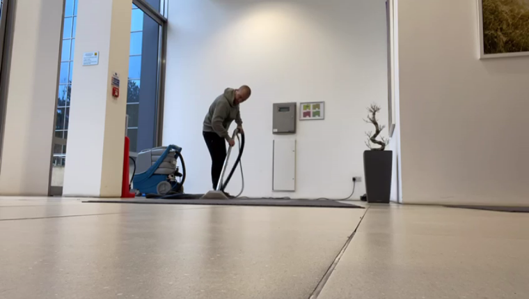 Picture of man cleaning a carpet